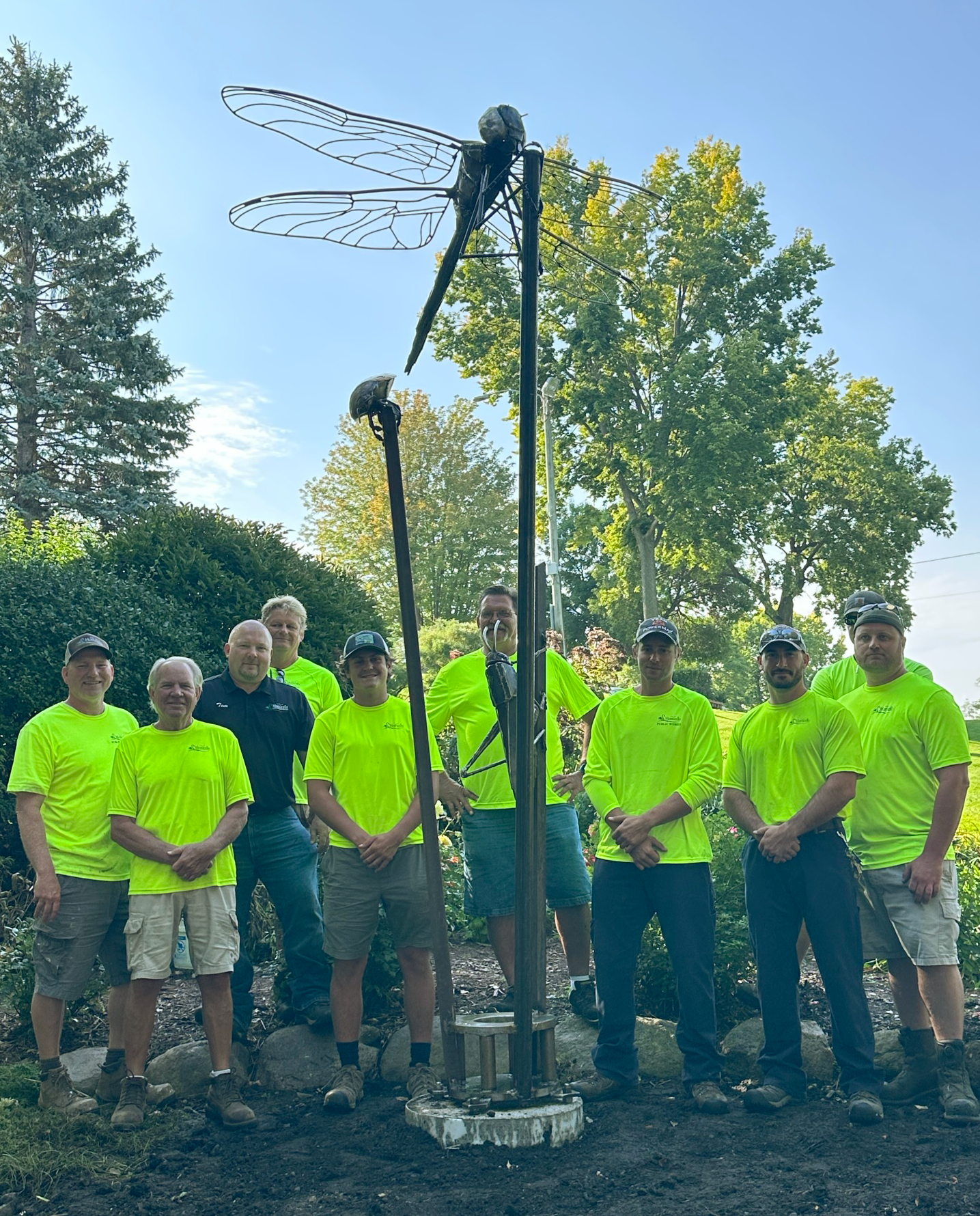 Parks, Arts, & Recreation staff with the new sculpture in East Bridge Park