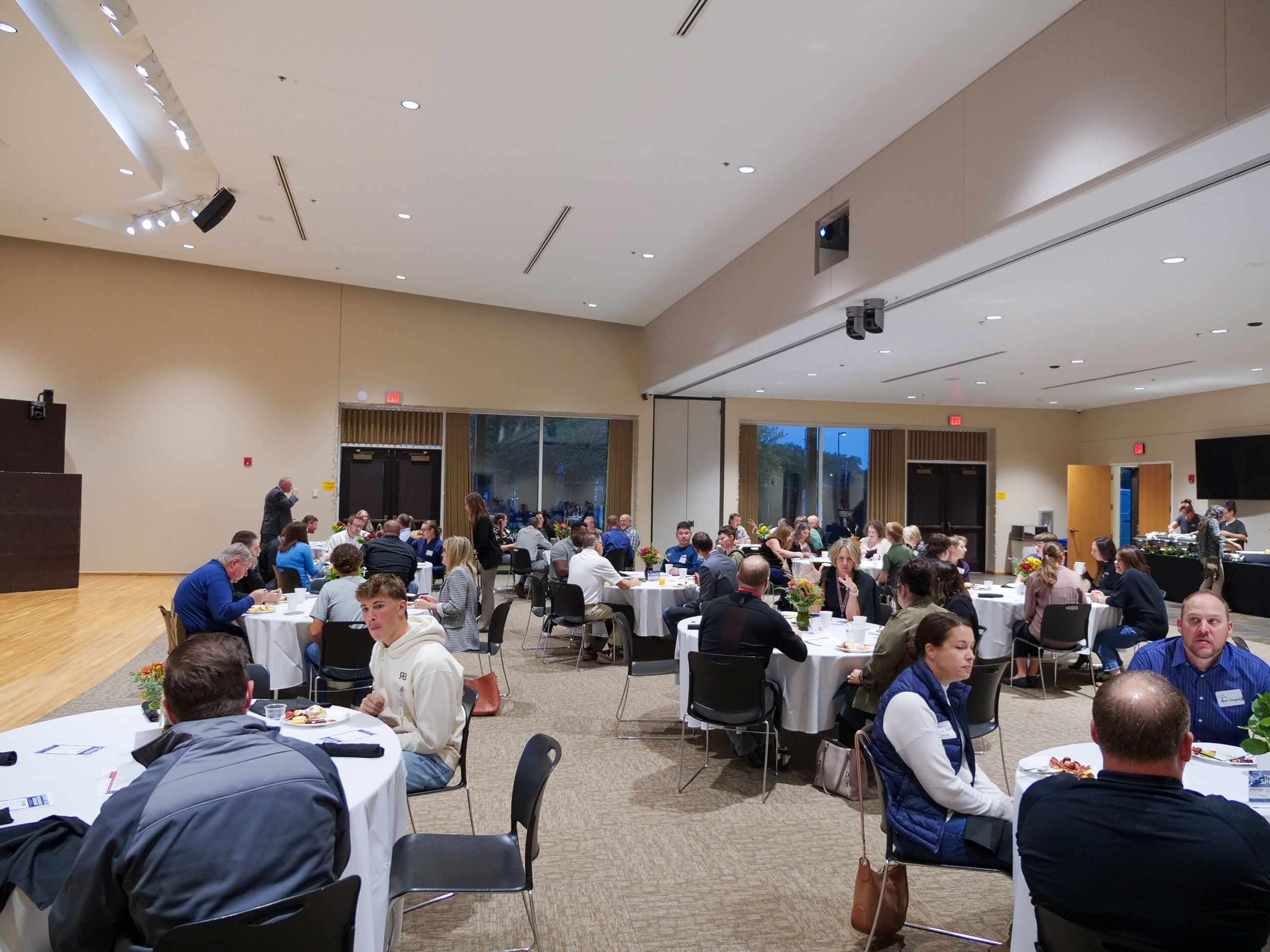 Manufacturers Breakfast large shot of room with guests.