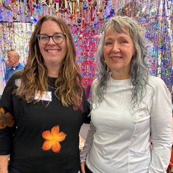 Two women standing next to each other. Erica Witzmann on the left and Sue Seeger on the right.