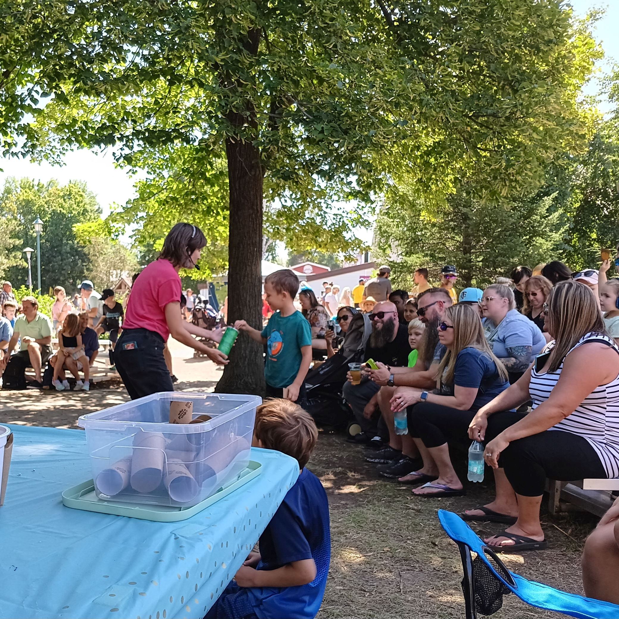 Families watching a story time performer.
