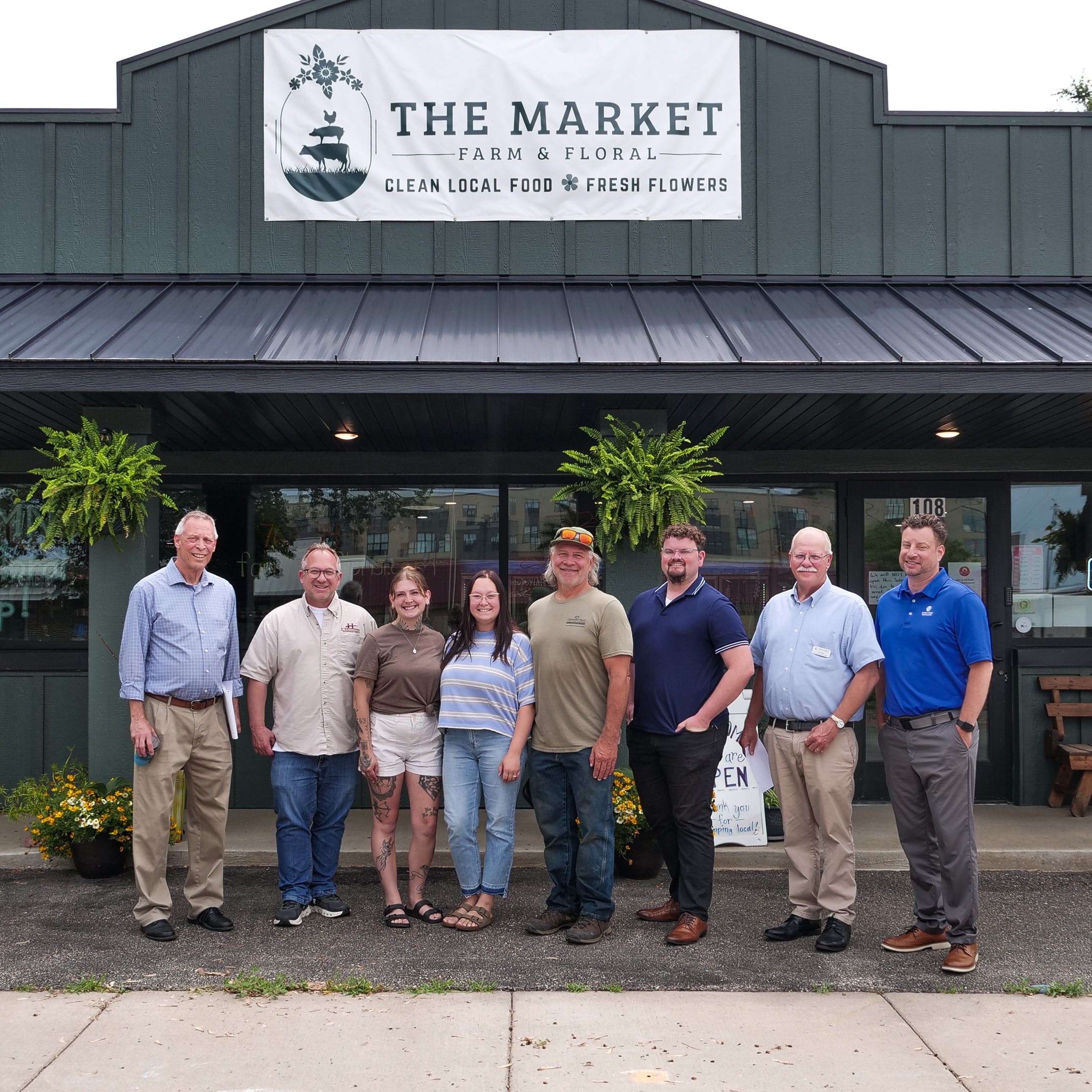 City staff, Monticello Mayor, IEDC members, and business owner outside of The Market in Monticello.
