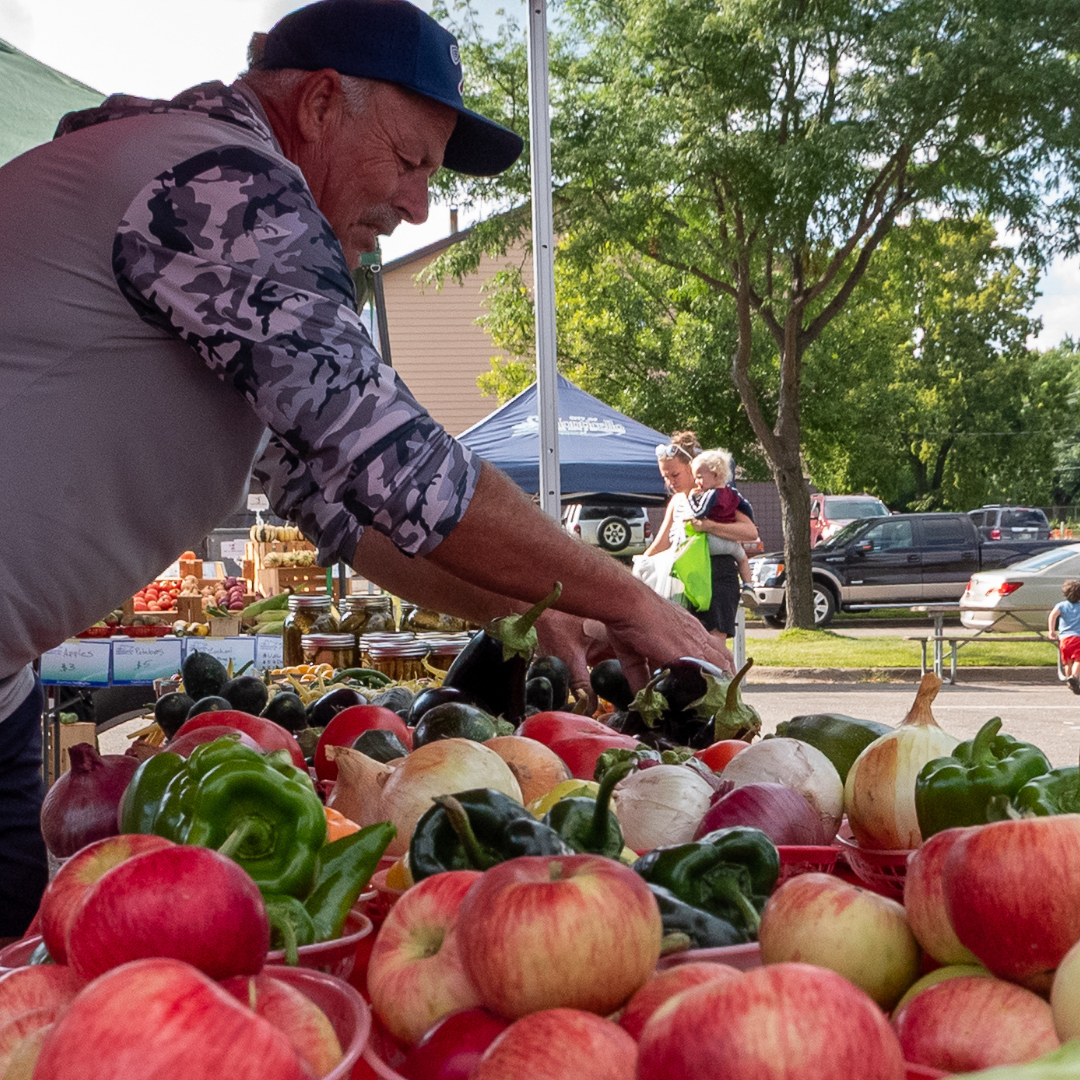 Farmers Market vendor organizing produce.